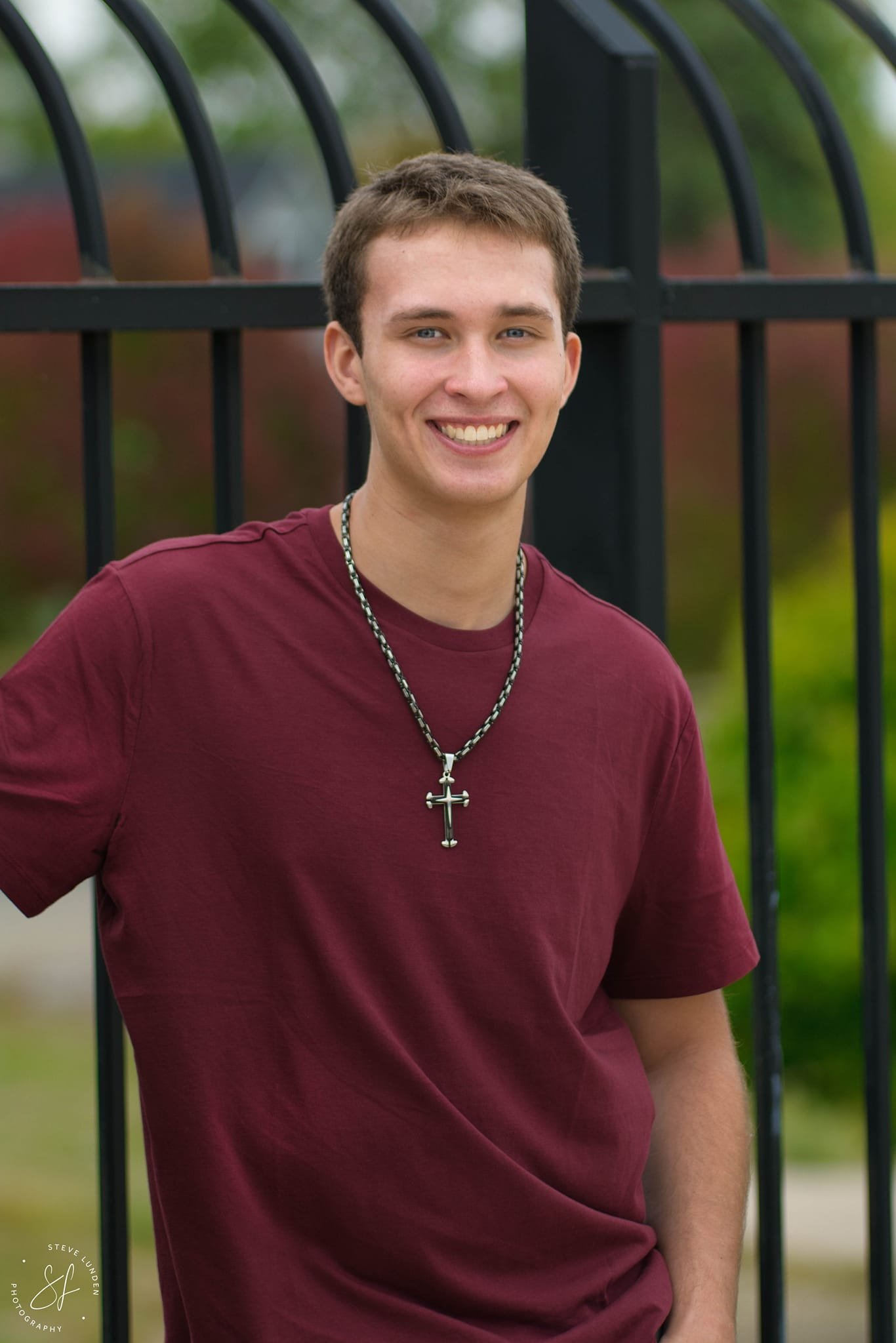 Senior girl posing in front of iron fence - urban portrait session Twin Cities MN
