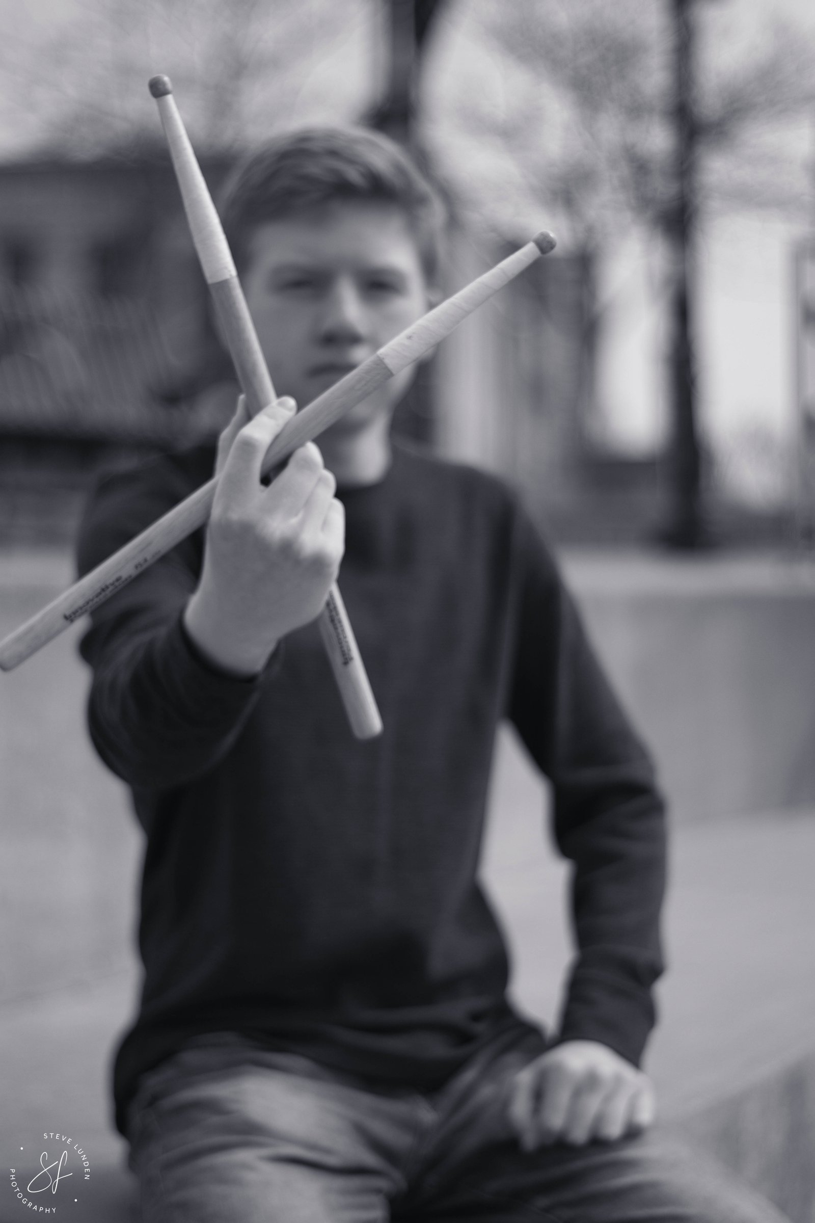 Creative senior portrait with drumsticks by Steve Lunden Photography Minneapolis